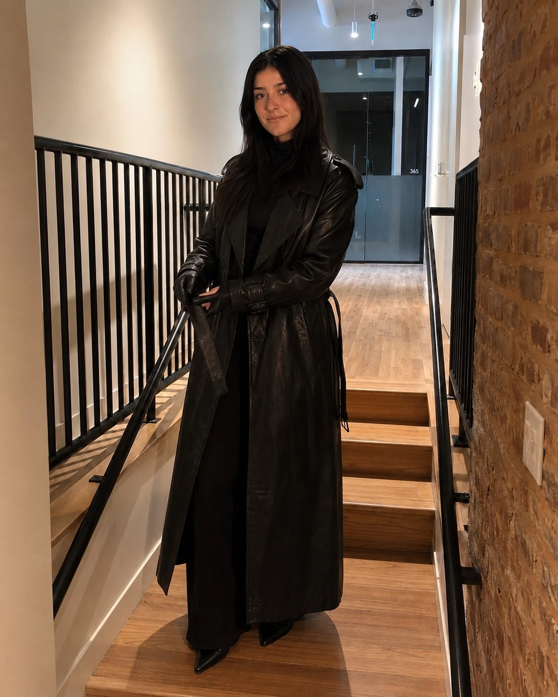 Model standing in a long black leather coat