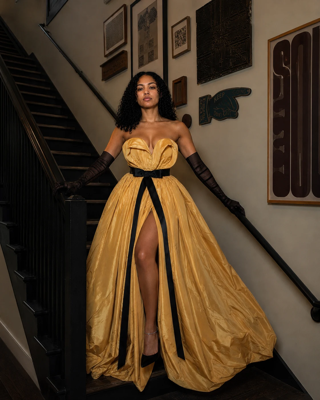 Model wearing a sculptural gold evening gown